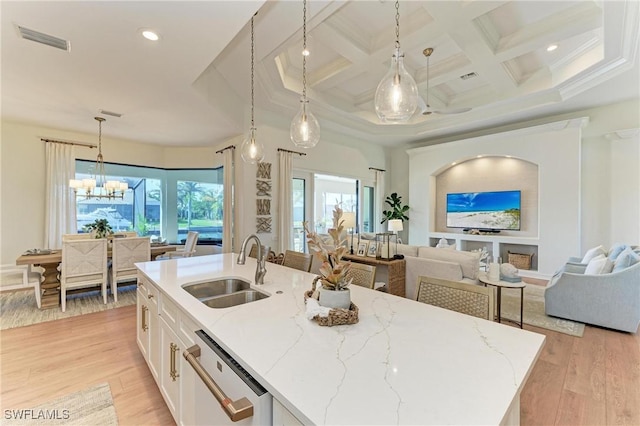 kitchen featuring visible vents, dishwasher, light wood-type flooring, white cabinetry, and a sink