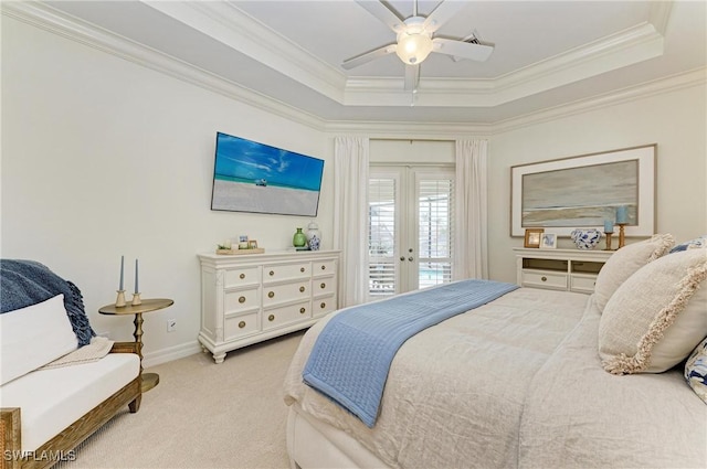 carpeted bedroom with french doors, a raised ceiling, crown molding, and access to outside