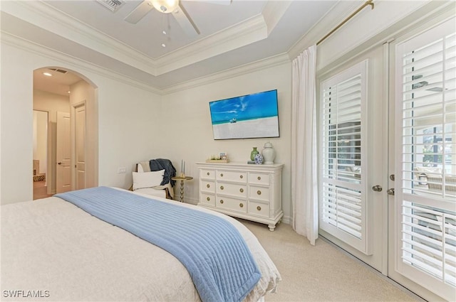 bedroom with ornamental molding, access to outside, arched walkways, a raised ceiling, and light colored carpet