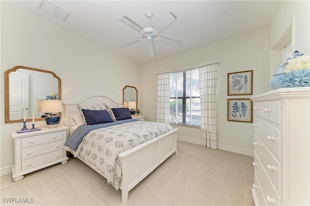bedroom featuring visible vents, light colored carpet, baseboards, and ceiling fan