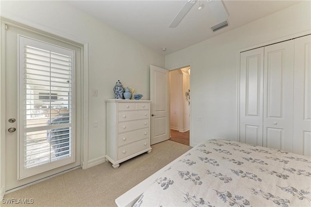 bedroom with light colored carpet, visible vents, a closet, and ceiling fan