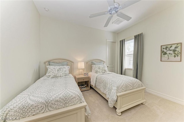 bedroom with visible vents, light carpet, baseboards, and a ceiling fan