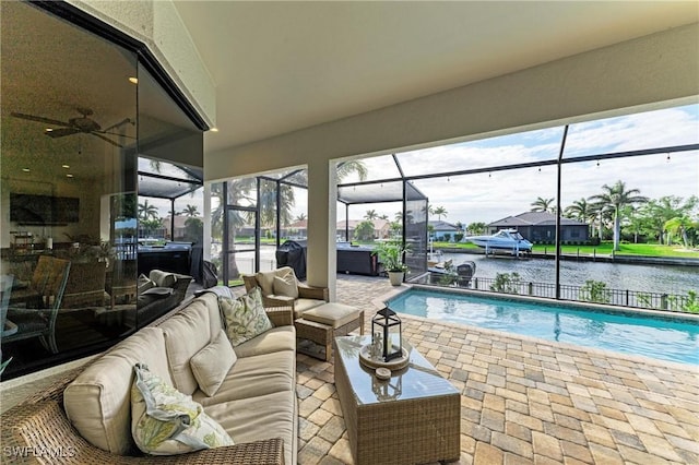 exterior space with a ceiling fan, a water view, and a sunroom