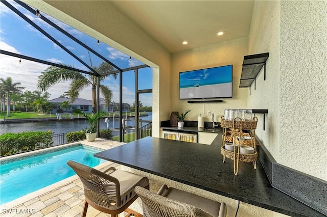 exterior space with glass enclosure, a patio, exterior kitchen, and a sink