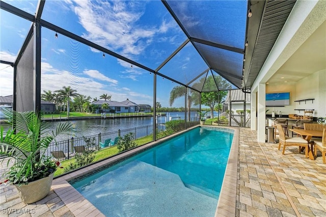 view of swimming pool featuring a water view, area for grilling, a fenced in pool, a lanai, and a patio area