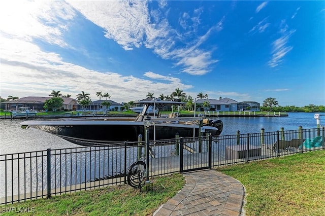 view of dock featuring fence, a water view, and a residential view
