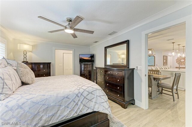 621 Trabue Ave, Punta Gorda, FL 33950 - bedroom featuring crown molding, light wood-style flooring, ensuite bathroom, visible vents, and ceiling fan