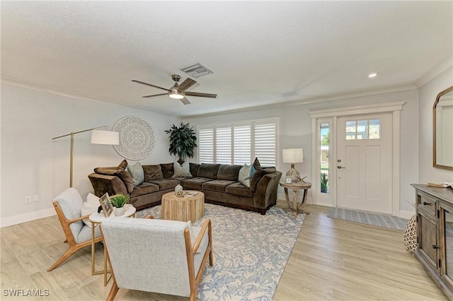 621 Trabue Ave, Punta Gorda, FL 33950 - living area featuring a ceiling fan, light wood finished floors, baseboards, visible vents, and ornamental molding