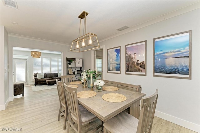 621 Trabue Ave, Punta Gorda, FL 33950 - dining area with ornamental molding, light wood-style floors, and visible vents