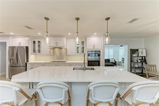 621 Trabue Ave, Punta Gorda, FL 33950 - kitchen with visible vents, white cabinets, a sink, and stainless steel appliances