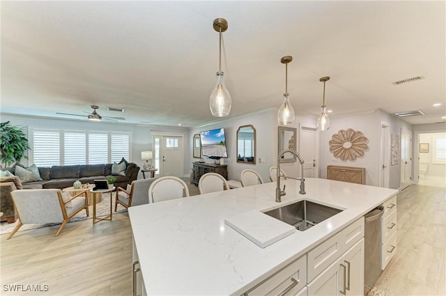 621 Trabue Ave, Punta Gorda, FL 33950 - kitchen featuring open floor plan, white cabinetry, a sink, light wood finished floors, and visible vents