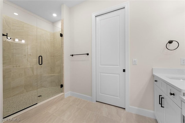 bathroom with baseboards, vanity, recessed lighting, and a shower stall