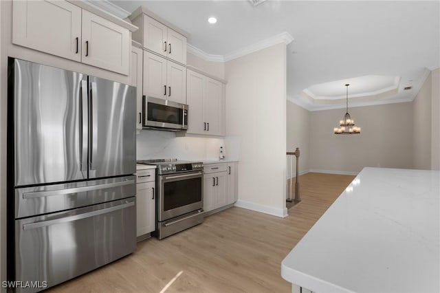 kitchen featuring backsplash, light wood-style flooring, ornamental molding, and stainless steel appliances