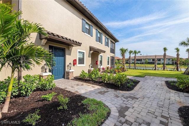 exterior space with a residential view, stucco siding, and a yard