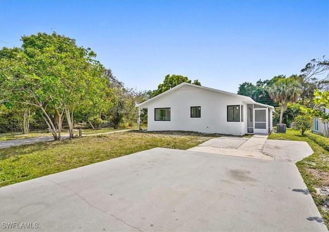 3652 Hibiscus Ave, Naples, FL 34104 - exterior space with a yard, cooling unit, and stucco siding