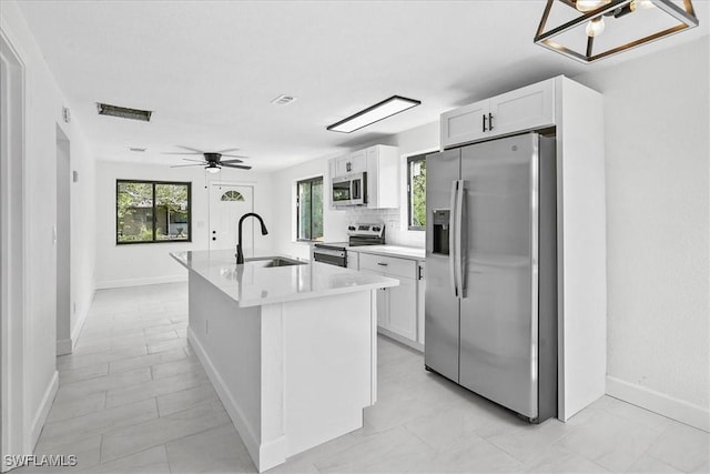 3652 Hibiscus Ave, Naples, FL 34104 - kitchen featuring a sink, a wealth of natural light, appliances with stainless steel finishes, and white cabinets