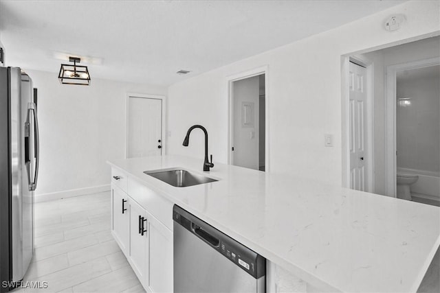 3652 Hibiscus Ave, Naples, FL 34104 - kitchen featuring visible vents, light stone countertops, stainless steel appliances, white cabinetry, and a sink