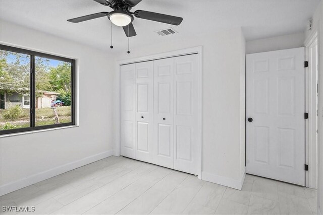 3652 Hibiscus Ave, Naples, FL 34104 - unfurnished bedroom with a ceiling fan, baseboards, visible vents, and a closet