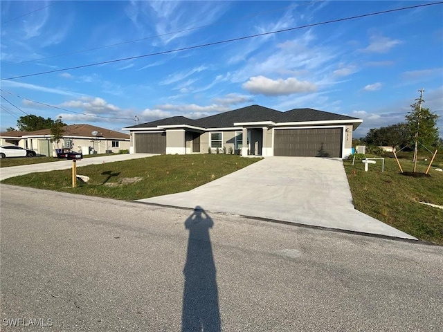 view of front of house featuring concrete driveway, a garage, and a front lawn