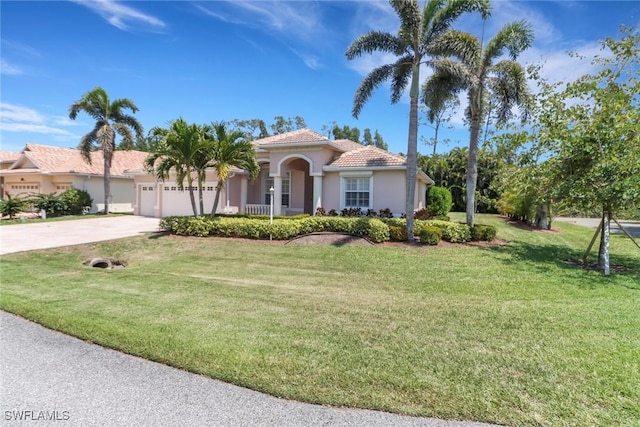 24840 Divot Dr, Bonita Springs, FL 34135 - mediterranean / spanish-style home featuring stucco siding, driveway, a garage, and a front lawn