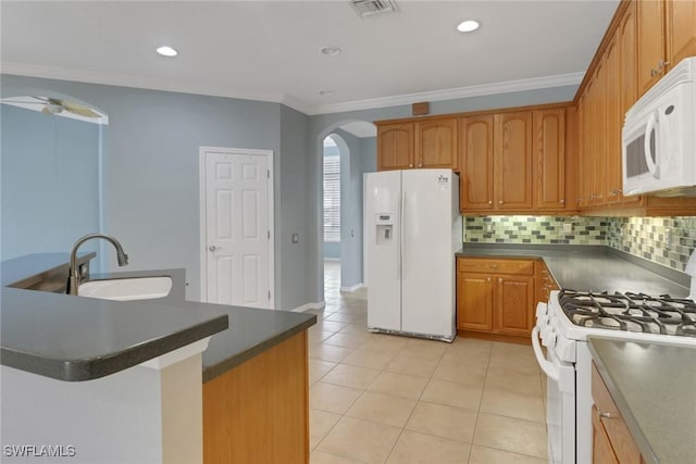 24840 Divot Dr, Bonita Springs, FL 34135 - kitchen featuring white appliances, arched walkways, a sink, dark countertops, and light tile patterned flooring