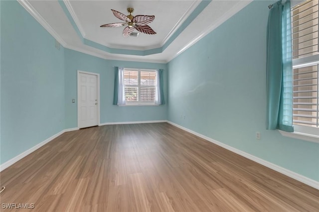24840 Divot Dr, Bonita Springs, FL 34135 - unfurnished room with a tray ceiling, wood finished floors, a ceiling fan, crown molding, and baseboards