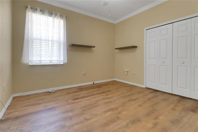 24840 Divot Dr, Bonita Springs, FL 34135 - unfurnished bedroom with ornamental molding, multiple windows, wood finished floors, and baseboards