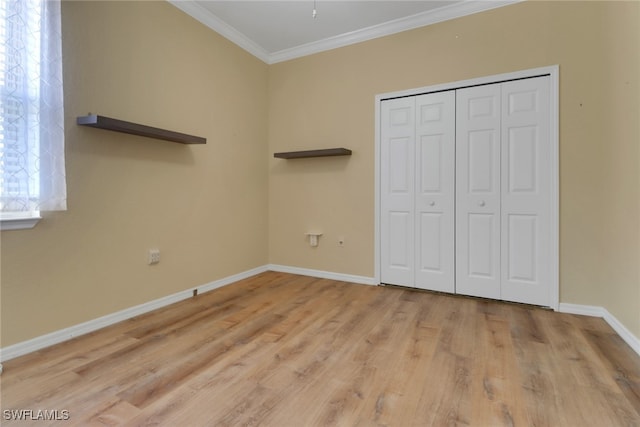 24840 Divot Dr, Bonita Springs, FL 34135 - unfurnished bedroom with ornamental molding, baseboards, light wood-style flooring, and a closet