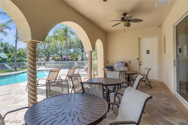 24840 Divot Dr, Bonita Springs, FL 34135 - view of patio / terrace with outdoor dining area, a ceiling fan, a community pool, and a grill