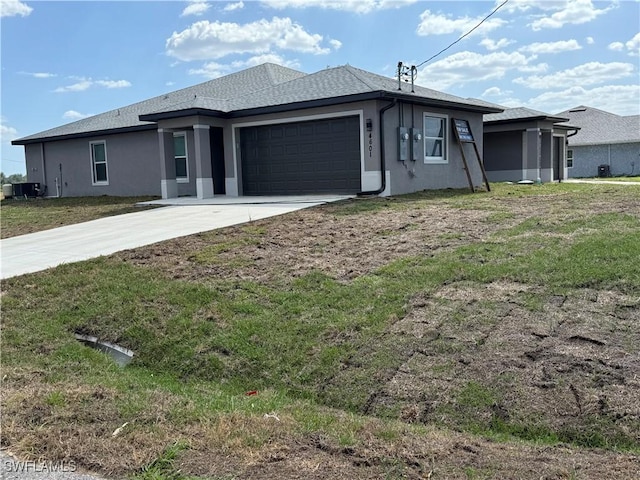 4601-4603 14th St SW, Lehigh Acres, FL 33973 - view of front of house with stucco siding, driveway, central air condition unit, and a garage