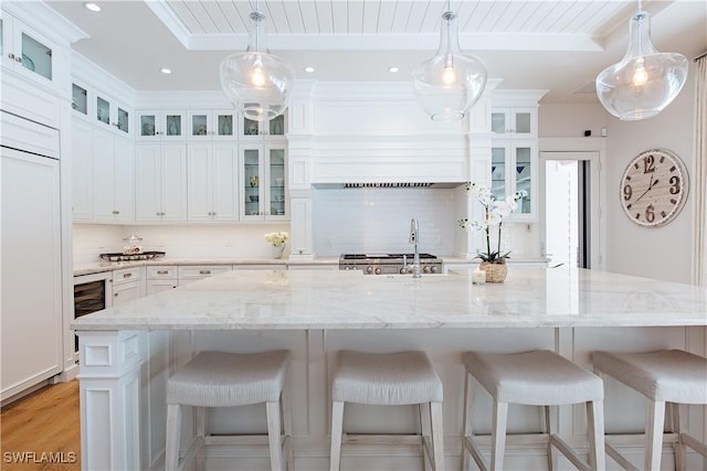 kitchen featuring white cabinetry, tasteful backsplash, and beverage cooler