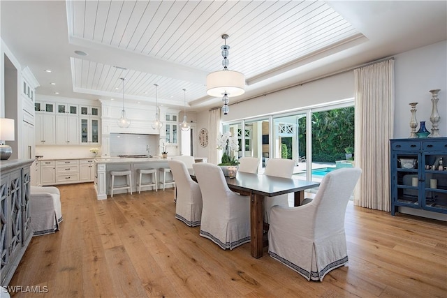 dining area with light wood finished floors, recessed lighting, a raised ceiling, and wood ceiling