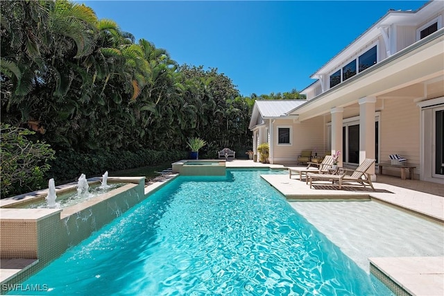 view of pool with a pool with connected hot tub and a patio area