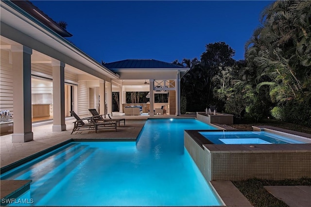 pool at twilight featuring an in ground hot tub, an outdoor pool, a patio area, ceiling fan, and an outdoor living space