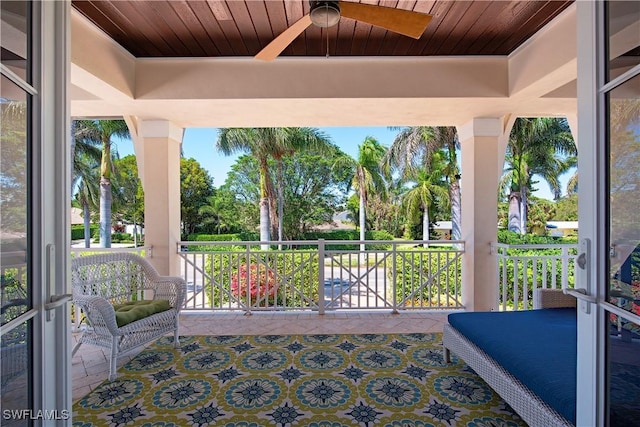 sunroom / solarium featuring a ceiling fan and plenty of natural light