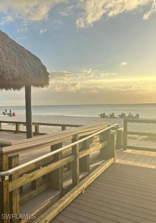 dock area featuring a beach view and a deck with water view