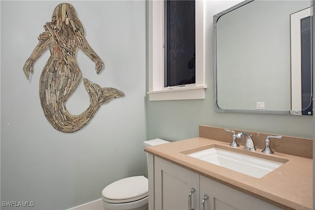 bathroom with toilet and vanity
