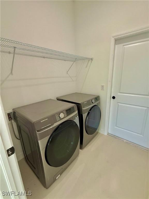 washroom featuring laundry area and washing machine and dryer