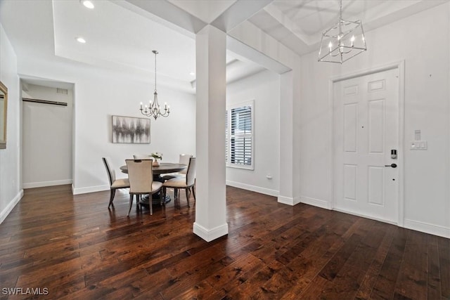 5135 Genoa St, Ave Maria, FL 34142 - foyer entrance with a notable chandelier, baseboards, dark wood-type flooring, and a tray ceiling