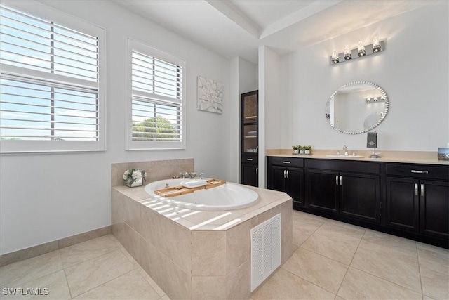 5135 Genoa St, Ave Maria, FL 34142 - full bathroom featuring visible vents, a garden tub, vanity, and tile patterned flooring