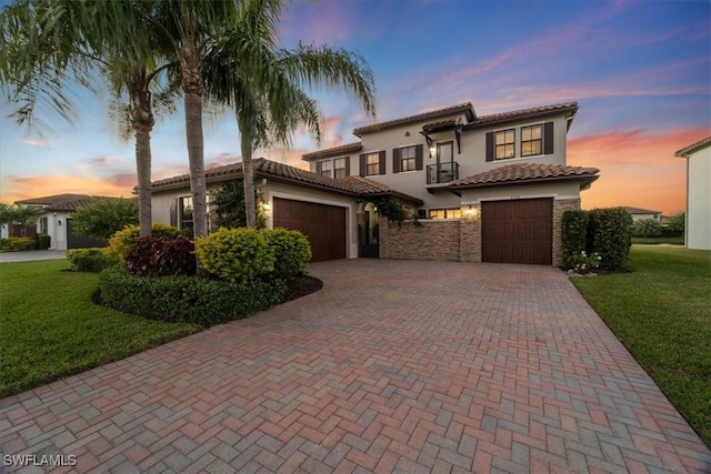 5135 Genoa St, Ave Maria, FL 34142 - mediterranean / spanish home featuring stucco siding, decorative driveway, a lawn, and a tiled roof