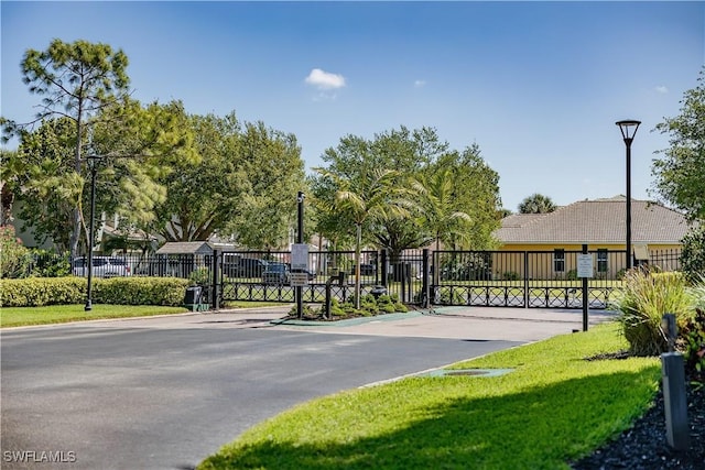 exterior space featuring a gate, street lighting, and a gated entry