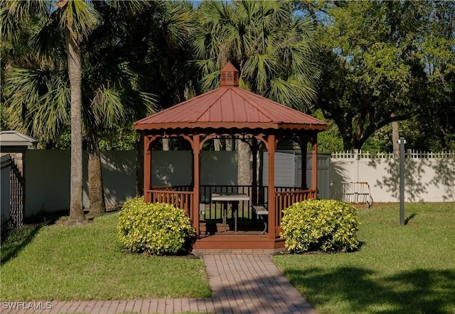 exterior space featuring a gazebo, fence, and a front yard