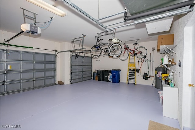 garage featuring gas water heater and a garage door opener