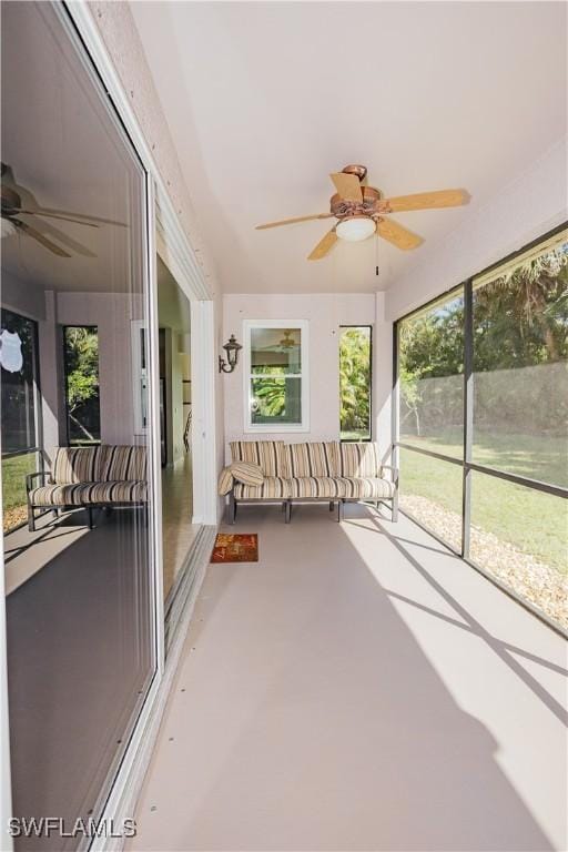 unfurnished sunroom with a ceiling fan
