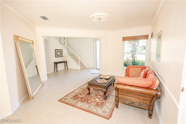 living room with visible vents, baseboards, stairs, and crown molding