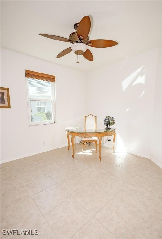 empty room with light tile patterned flooring, baseboards, and a ceiling fan