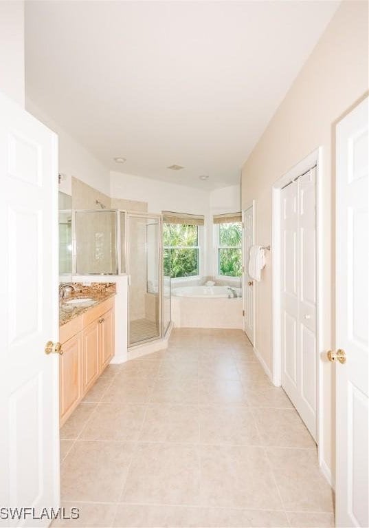 full bath featuring vanity, a garden tub, tile patterned flooring, and a shower stall
