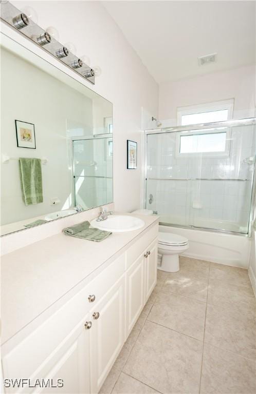 full bathroom with visible vents, toilet, tile patterned flooring, enclosed tub / shower combo, and vanity