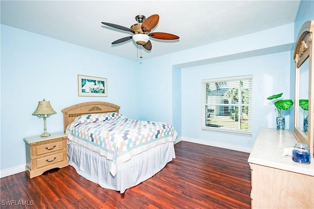 bedroom featuring baseboards, ceiling fan, and dark wood-style flooring